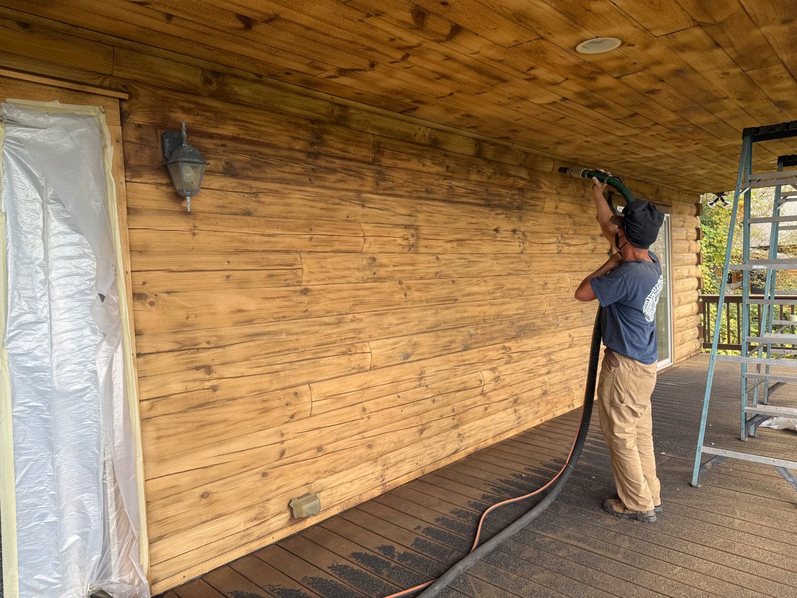 ProFlow crew preparing wood siding for restoration
